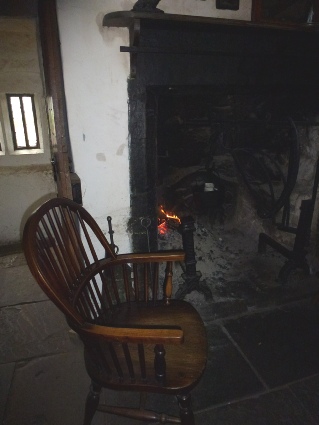 Wooden chair by fireplace.